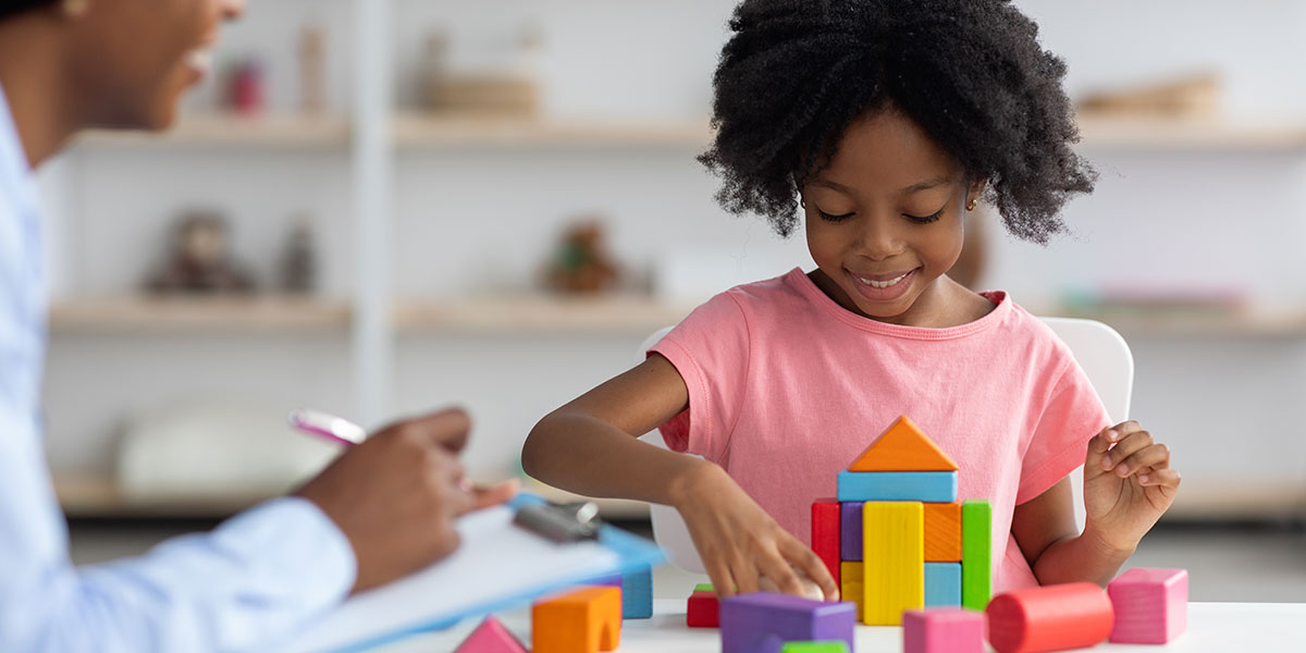 A child development specialist working with a child.